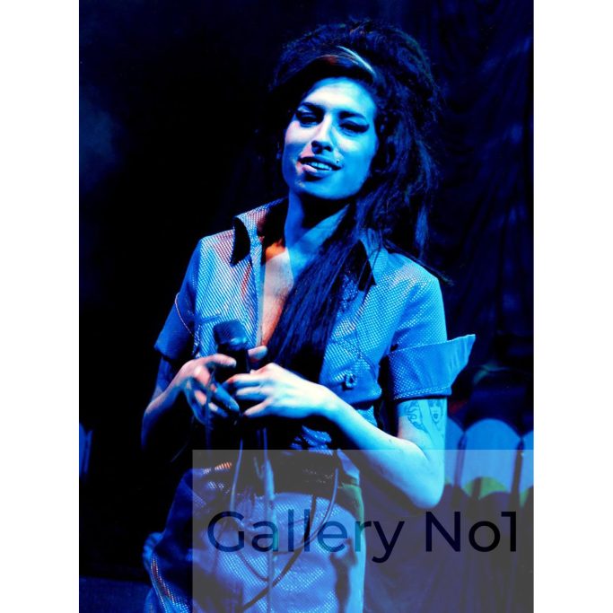 Find an early photograph of Amy Winehouse performing on stage