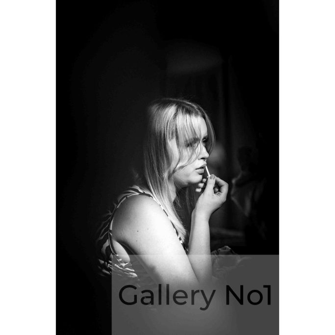 Find street photography of young girl putting on lipstick