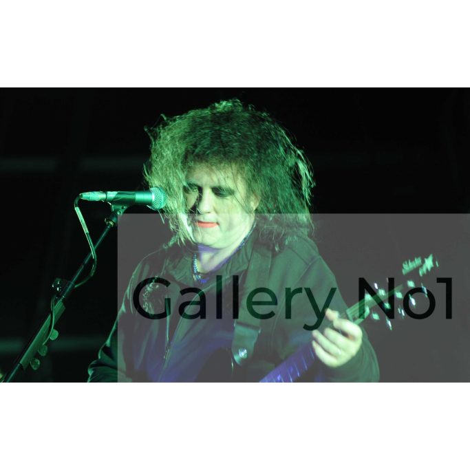 Look for a Paul Windsor photograph of The Cure performing on stage